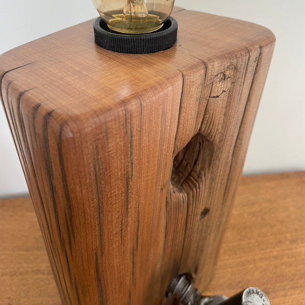 Tōtara Fence Post Lamp with Hinge and replica edison bulb, close up of polished front grain, handcrafted by shades at grays.