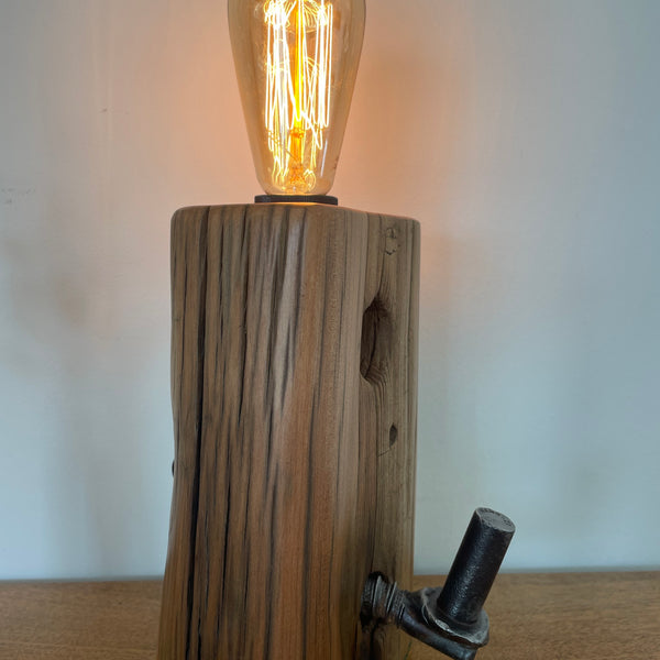 Tōtara Fence Post Lamp with Hinge and replica edison bulb, diagonal front view, handcrafted by shades at grays.