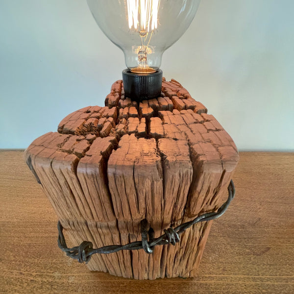 Naturally eroded top, polished with natural bees wax hand crafted in to upcycled wood table lamp by shades at grays.
