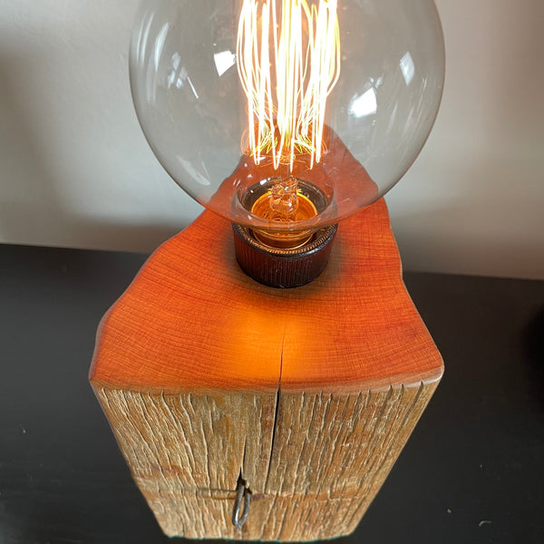 Wood table lamp handcrafted by shades at grays from reclaimed totara fence post, with old staple in postion, front and top view, by shades at grays.