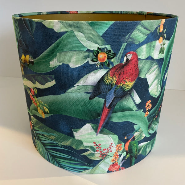 Tropical bird fabric medium drum lampshade, by shades at grays with gold inner, and red parrot.