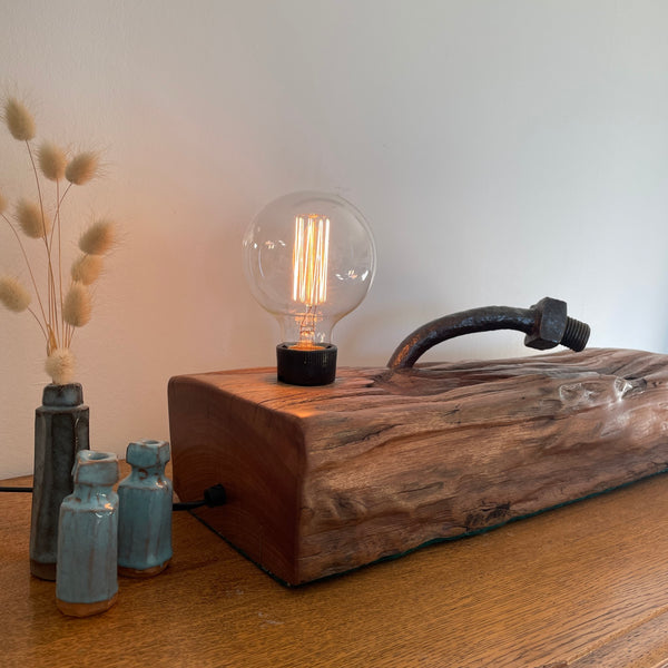 Wood lamp from 100 year old reclaimed wharf timber, with large original bolt, smooth polished end grain and side view, lit, crafted by shades at grays