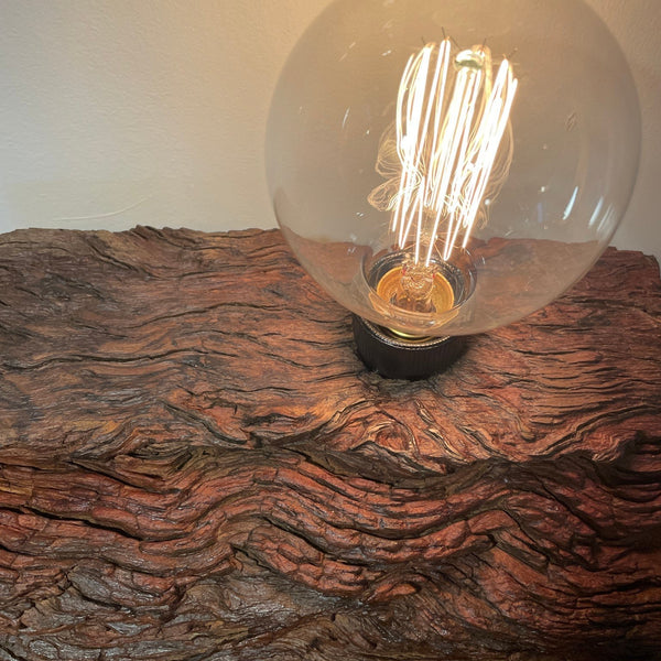 Rustic wood table lamp handcrafted from upcycled jarrah wharf timber, close up of wave patterned erosion grooves, by shades at grays.