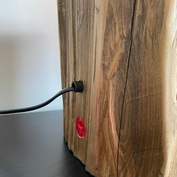 Tōtara fence post table lamp from Shades at Grays  close up of polished back view, with makers branding mark and black lead.