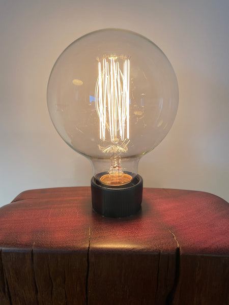 Upcycled jarrah wharf wood lamp, cleaned and polished with natural beeswax, smooth top and replica edision bulb, lit, handcrafted by shades at grays.