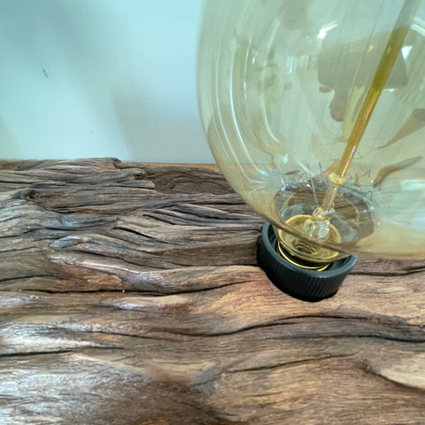 Upcycled wharf timber table lamp, handcrafted by shades at grays, close up of natural grain and replica edison bulb, unlit, top view.
