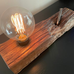Upcycled wood table lamp from origianl wharf timber, vintage nail and replica edison bulb, lit, hoverview, sold by shades at grays.