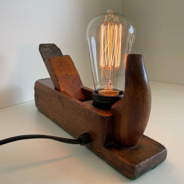 Vintage table lamp, handcrafted from carpenters wood plane,back view with black lead.