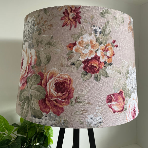 Vintage style floral pattern of reds and cream blossoms on blush pink background, unlit, handcrafted by shades at grays.