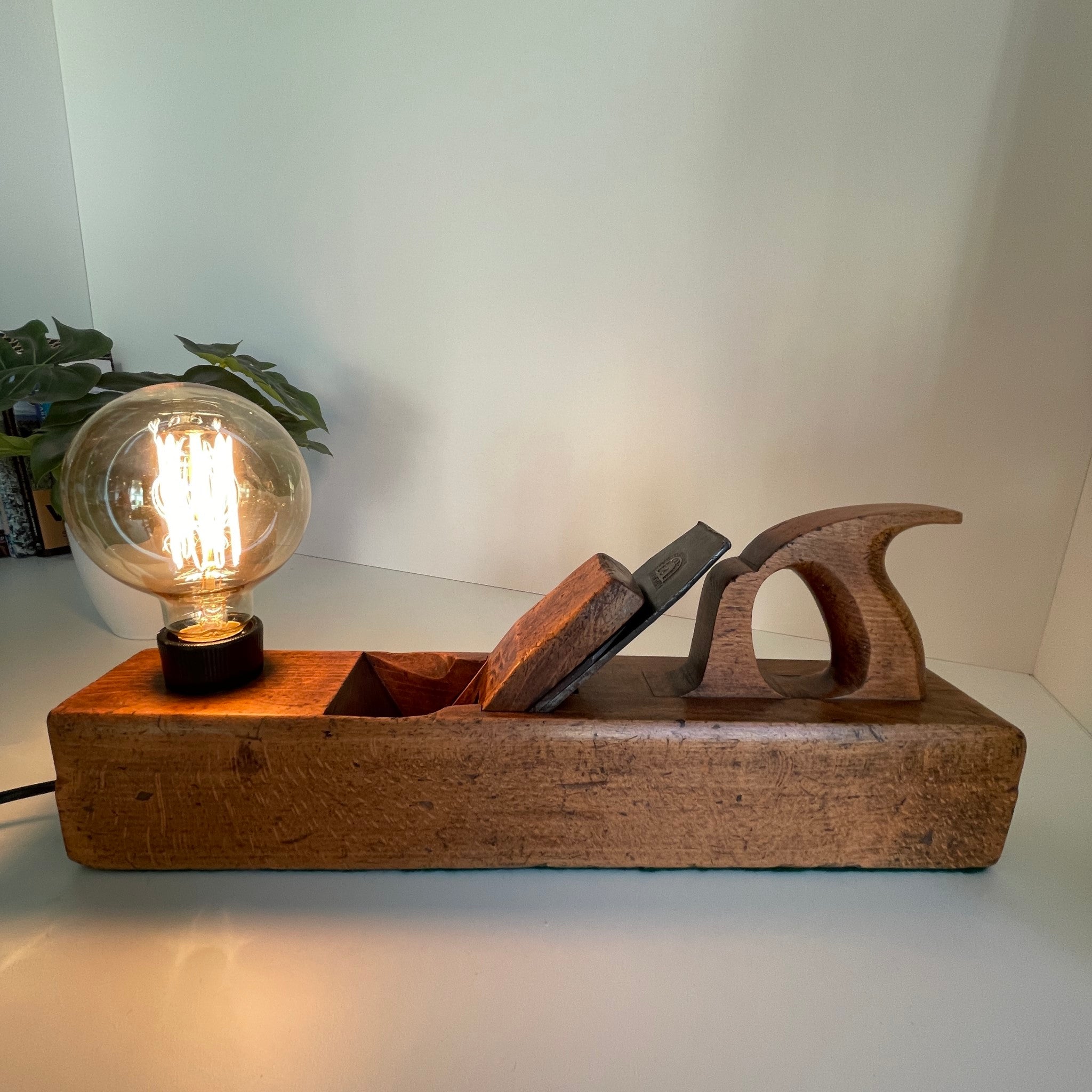 Vintage table lamp, old wood plane with edison bulb, crafted by shades at grays, nz. Full front view.