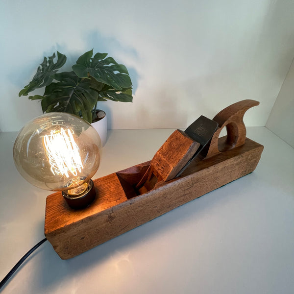 Vintage table lamp, old wood plane with edison bulb, crafted by shades at grays, nz. Top angle view.