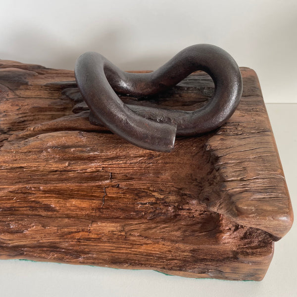 Wharf timber art piece or door stop with railway iron, close up of pandrol clip and eroded timber, crafted  by shades at grays.