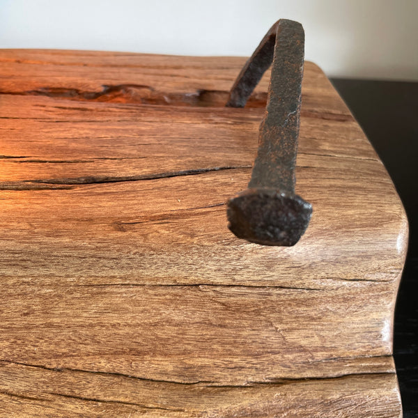 Close up of original iron nail and smooth wood grains.