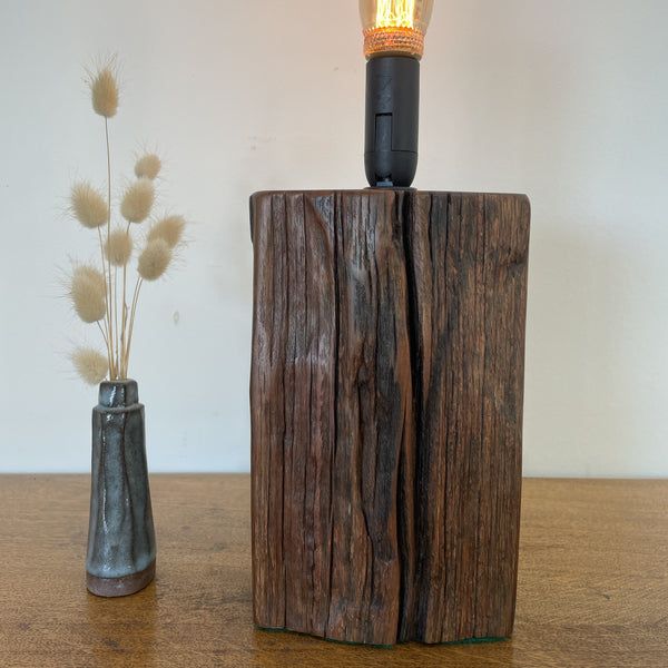 Wharf timber table lamp with candle bulb and deep brown grain, upcycled by shades at grays, short front view.