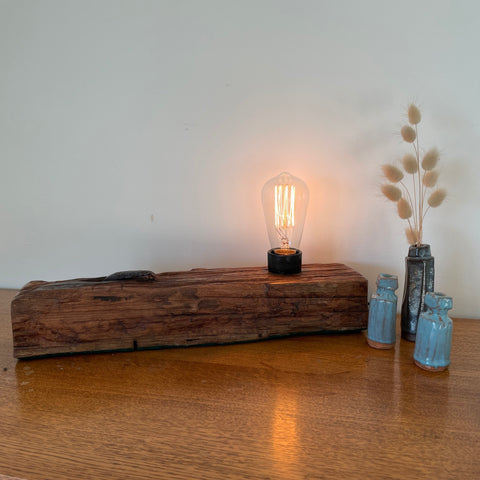 Wharf timber table lamp with edison bulb handcrafted by shades at grays, lit, front view.