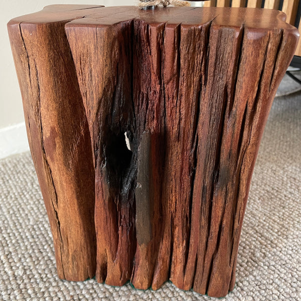 Wood door stop with authentic tar marks and erosion grooves, and polished railway pandrol clip, crafted by shades at grays, close up of front and top view.