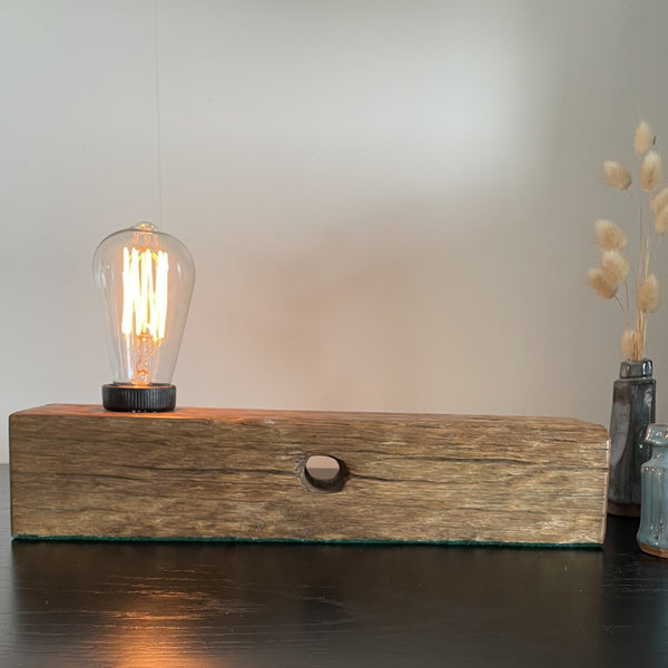 Wooden table lamp upcycled from old telegraph pole with edison bulb, front view with original bolt holes, by shades at grays.