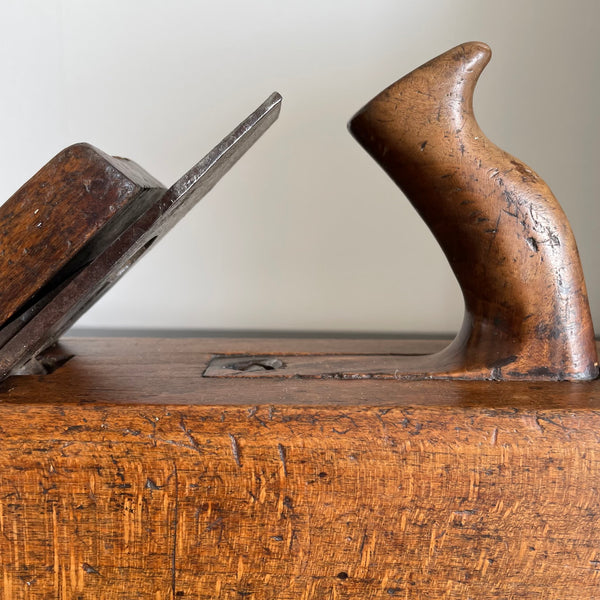 Wooden table lamp crafted from vintage carpenter's plane, cleaned and polished with natural beeswax, close up.