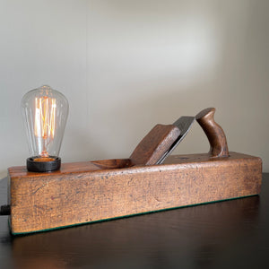 Wooden table lamp crafted from vintage carpenter's plane, cleaned and polished with natural beeswax with replica edison bulb by shades at grays, nz.