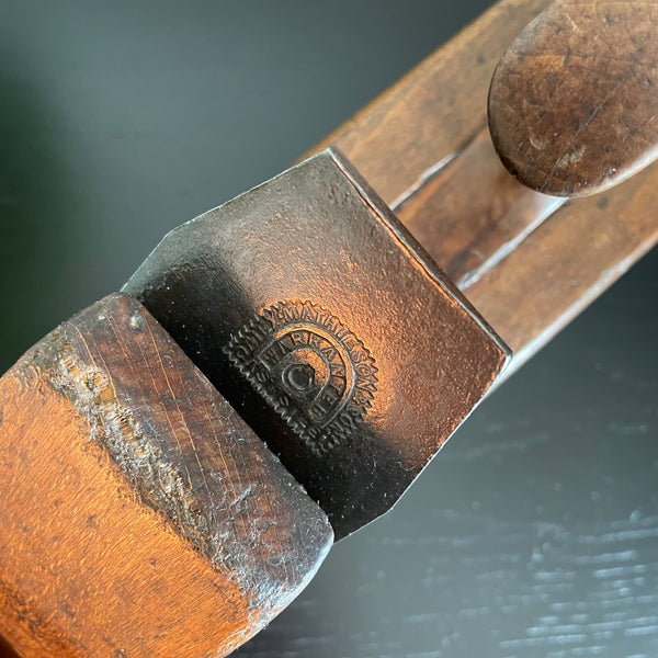 Wooden table lamp crafted from vintage carpenter's plane, close up of authentic 19th century brand.