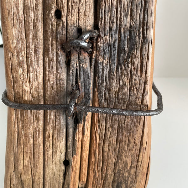 Close up of original fence post wire and staples on upcycled wooden table lamp.