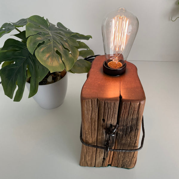 Wooden table lamp handcrafted from vintage totara post with original wire and replica edison bulb, polished smooth top grain,