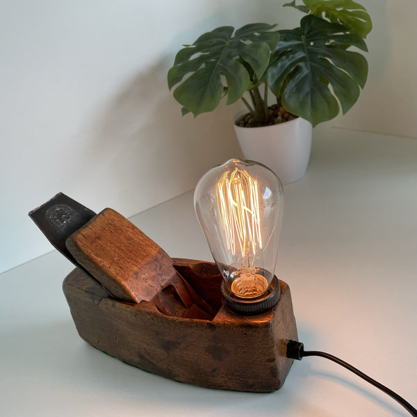 Wooden table lamp made from vintage carpenters plane, with edison light bulb crafted by shades at grays.