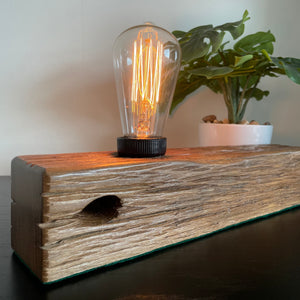 Wooden table lamp upcycled by shades at grays from old telegraph post, close up of bolt hole.