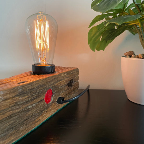 Wooden table lamp upcycled by shades at grays from old telegraph pole, rear view, with black lead.