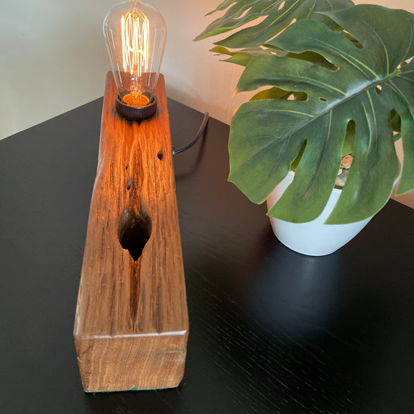 Wooden table lamp upcycled by shades at grays from old telegraph pole, top and right hand edge view.