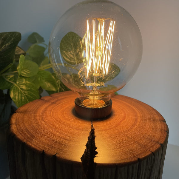 Wooden table lamp upcycled from authentic jarrah telegraph pole with edison bulb. Polished smooth top and eroded scar.