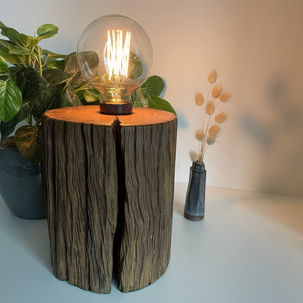 Wooden table lamp upcycled from authentic jarrah telegraph pole with edison bulb, lit. Made by shades at grays.