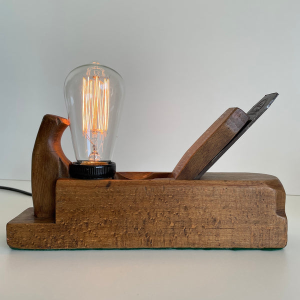 Wooden table lamp crafted from old carpenter's wood block plane, with edison bulb, lit. Upcycled by Shades at Grays.