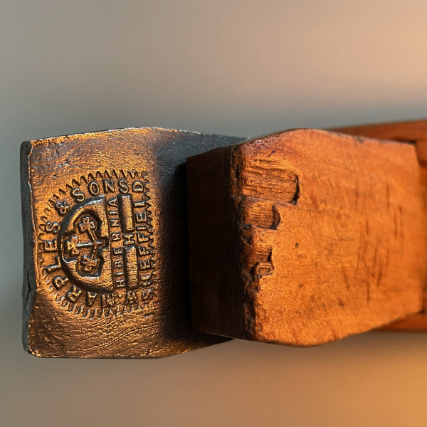 Wooden table lamp upcycled from vintage carpenters plane with edison bulb. Close up of 19th century manufacturers brand.