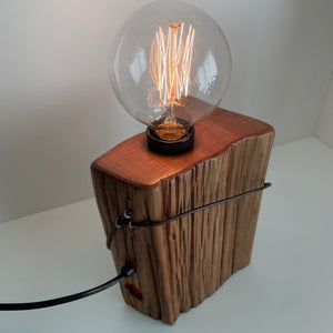 Wooden table lamp handcrafted from rustic totara fence post, by shades at grays, polished top grain.