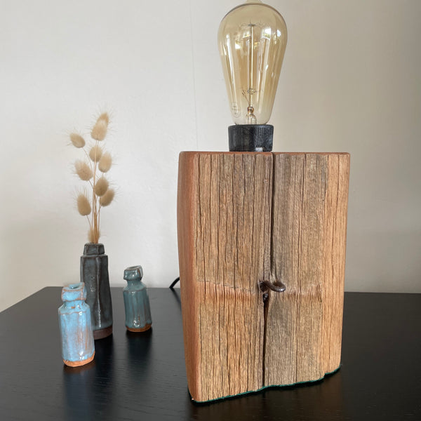 Wood table lamp crafted by shades at grays from old totara post with original staple, unlit.