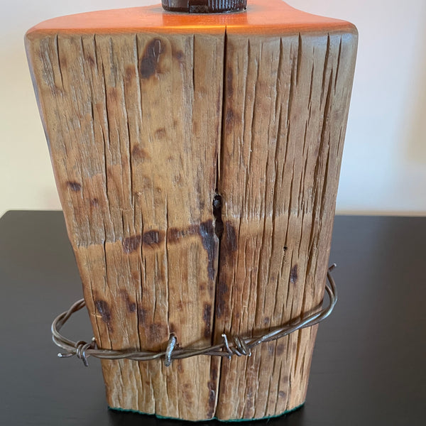 Wood table lamp crafted from reclaimed tōtara post with authentic barbed wire and the adition of an edision bulb, close up of front and barbed wire, by shades at grays.