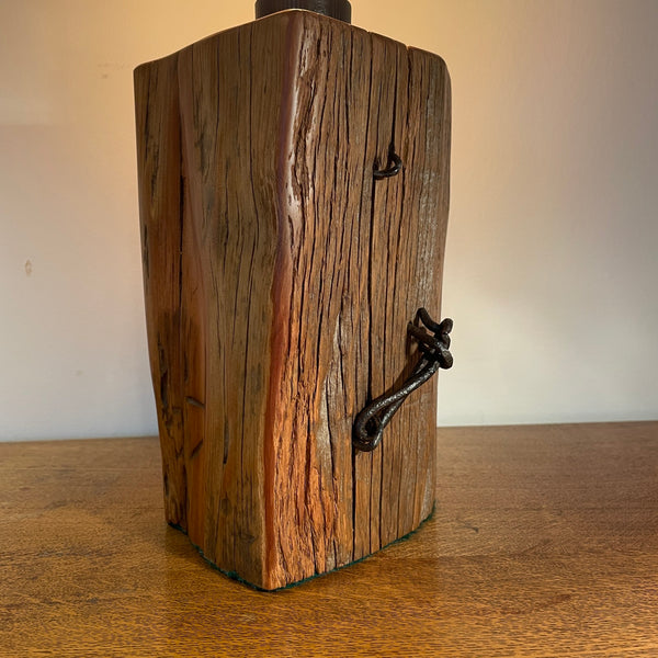 Wooden lamp base with original wire and staples,  on a wooden surface