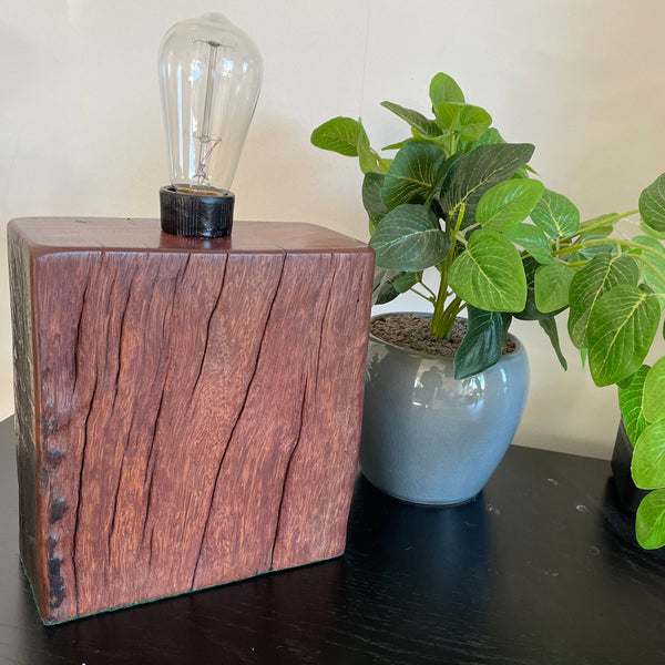 Hand crafted wood lamp created from reclaimed wharf timber, unlit, front view.