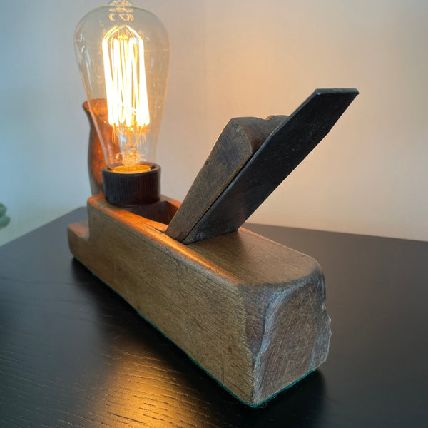 Wood table lamp made from vintage wood block with replica edison bulb, by shades at grays, front and back view, lit