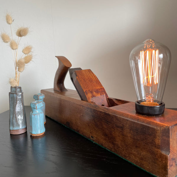 Wooden table lamp upcycled from authentic carpenter's plane, lit, crafted by shades at grays nz.