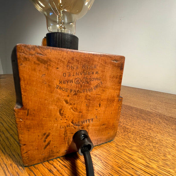 Wood table lamp upcycled from large carpenter's plane with replica edison bulb, unlit, close up of authentic branding and carpenter's marks.