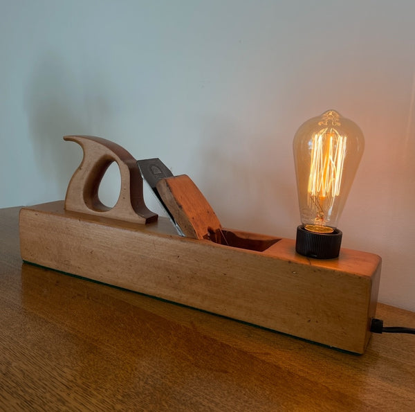 Wood table lamp upcycled from large vintage carpenters plane, long view of angled lamp, by shades at grays