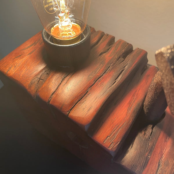 Wood table lamp upcycled from wharf timber with large vintage bolt and replica edison bulb, lit, close up of erosion grooves and bolt, close up, 
handcrafted by shades at grays.