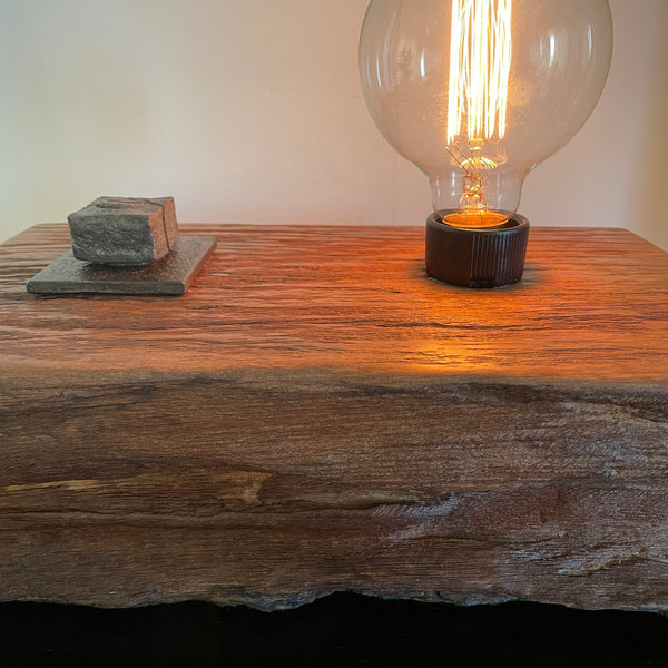 Wood table lamp upcycled from wharf timber with original bolt and edison bulb, close up of front mid section by shades at grays.