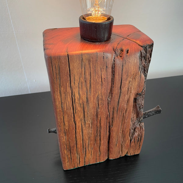 Wood table lamp with marks of water erosion and retained original nail, smooth top, by shades at grays nz.