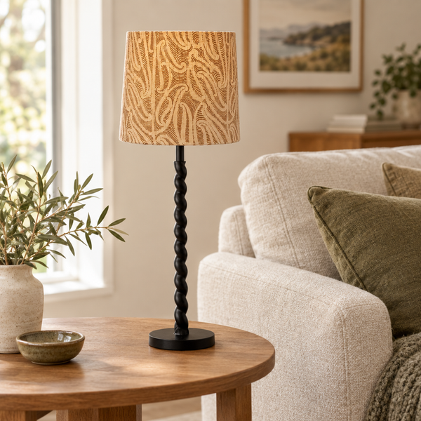 Black twist lamp with a patterned shade in a warm living room