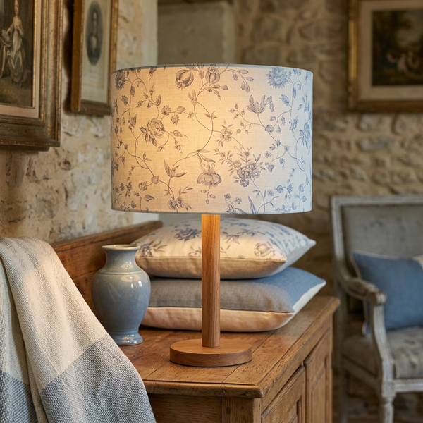 Drum lampshade in Pivoine Ciel Blue fabric on a timber lamp base in a French country living room
