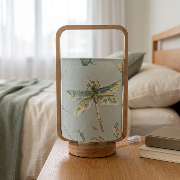 Eggshell-blue dragonfly table lamp styled on a timber bedside table