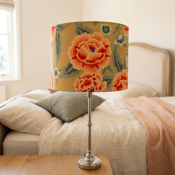 Embroidered Shawl lampshade on a slender silver base in a bedroom
